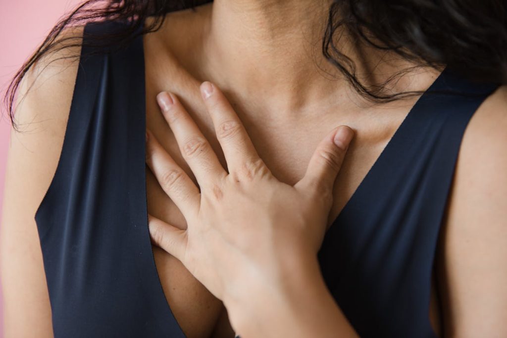 A woman is holding her chest